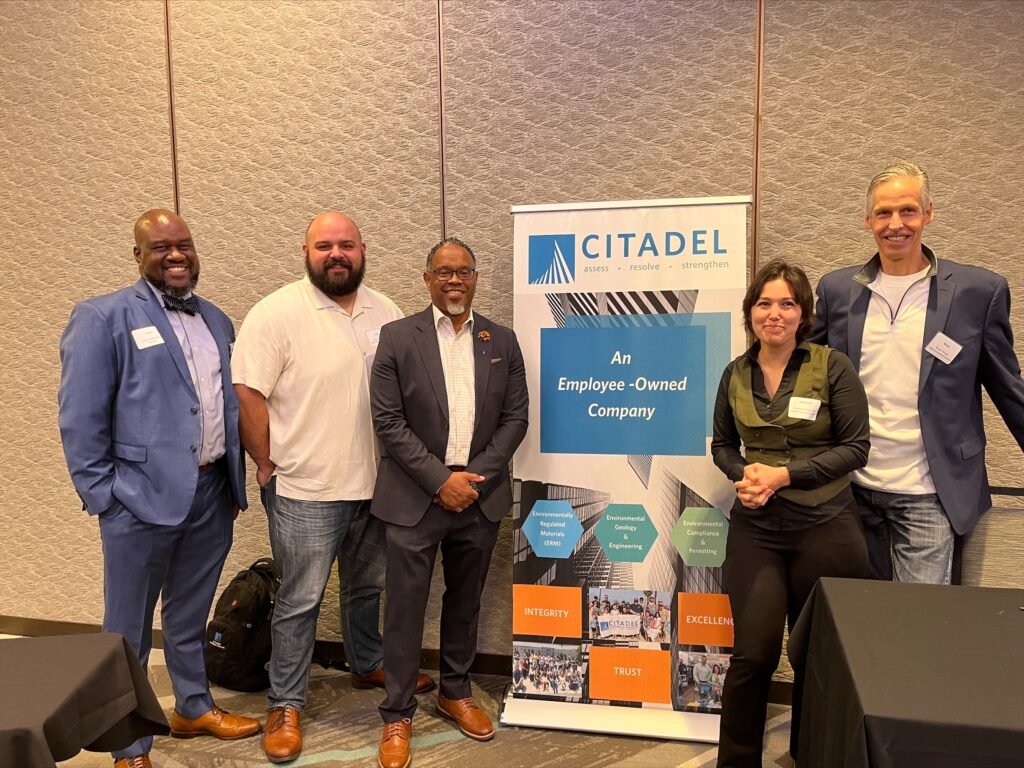 An image of a group of people at the BuildLACCD event. From left to right: Hakim Chambers, Josh Laprease, Dr.Ruben Smith, Cheyenne Summers, and Bruce Thrupp. They stand in from of a Citadel EHS banner